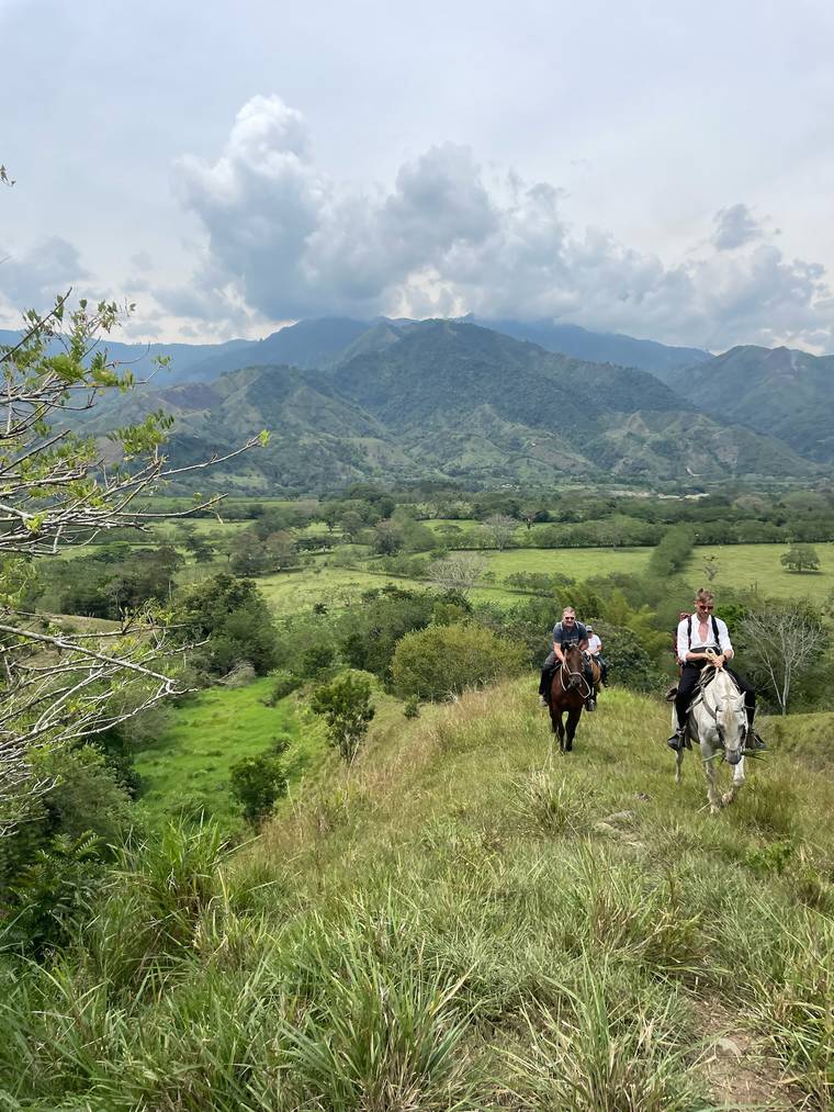 Horseback riding through the green hills
